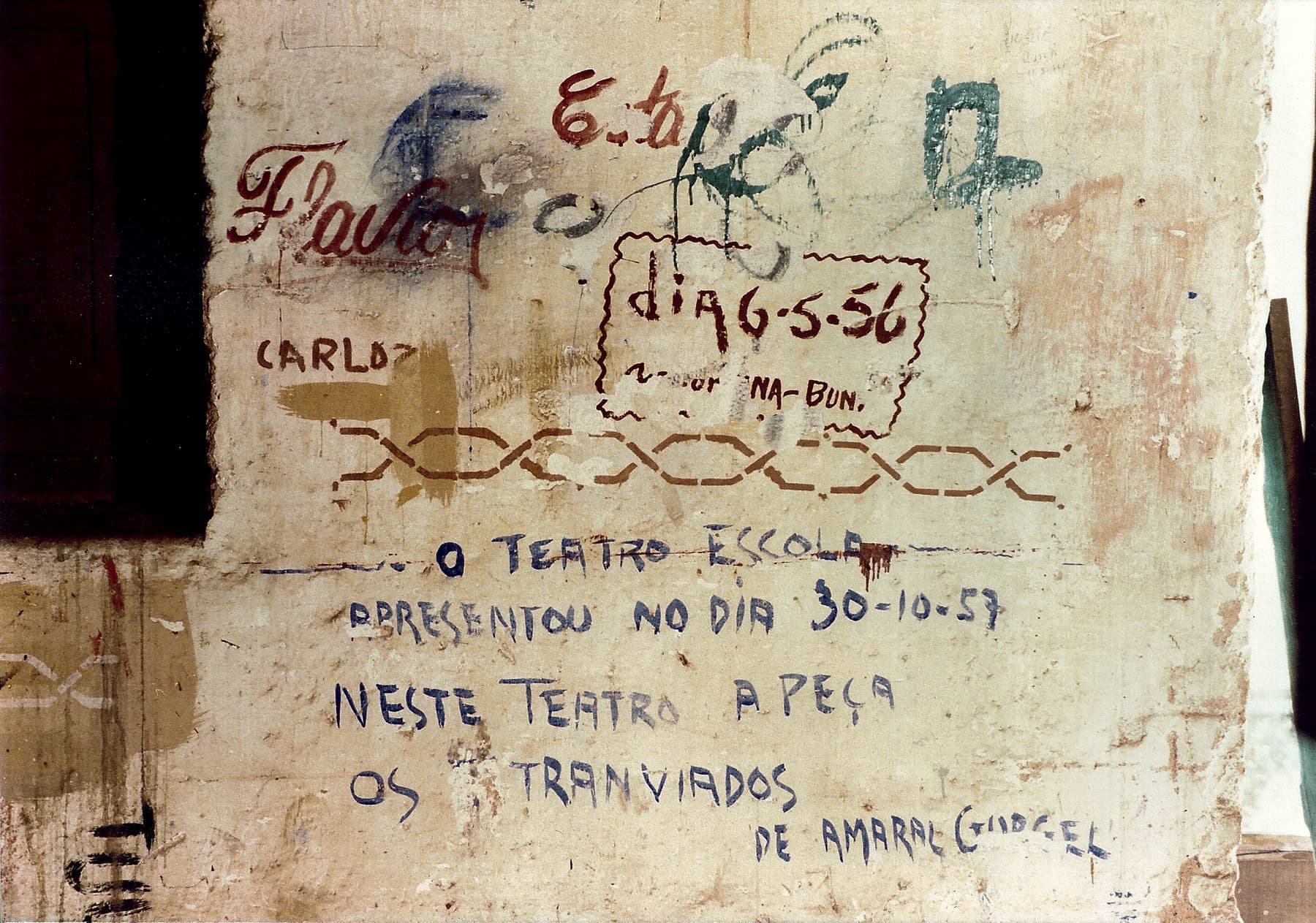 Marcas de antigas companhias gravadas na lateral do palco — assinaturas de quem passou pela casa.