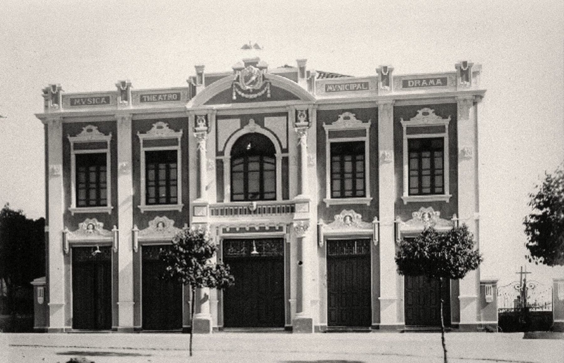 A fachada do Theatro em registro antigo — no alto, a faixa de inscrições do programa: MVSICA, THEATRO, MVNICIPAL, DRAMA.